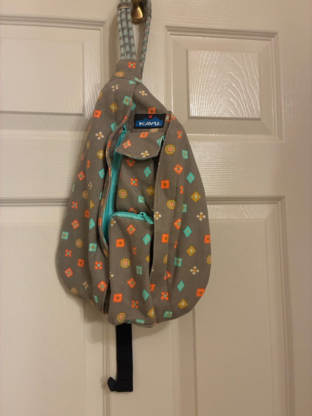 Kavu taupe sling bag with turquoise &‎ orange geometric print